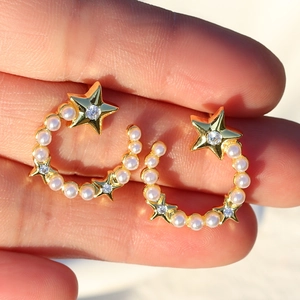Gold-plated star and moon earrings featuring delicate pearls and sparkling cubic zirconia