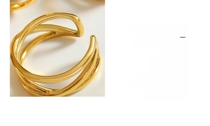 Macro shot of three-layer spiral crossover open ring with polished gold mirror finish