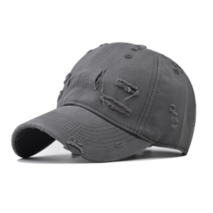 Close-up of ripped details and distressed texture on a vintage cotton baseball cap