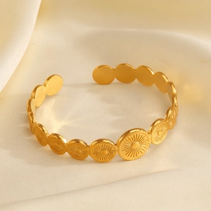 Minimalist gold-plated stainless steel cuff bracelet with embossed sunburst pattern