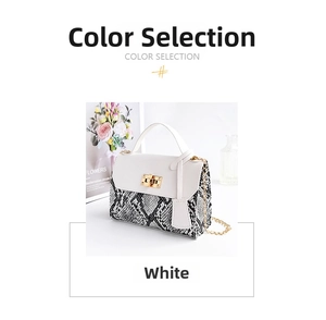 Close-up of stylish white and snakeskin pattern crossbody bag with golden chain strap