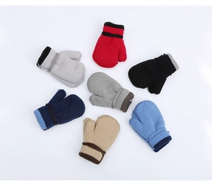 Flat lay of knit toddler mittens in six colors with contrast striped ribbed cuffs