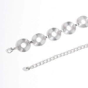 Close-up of silver metal waist chain with hollow engraved rings and lobster clasp