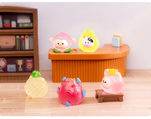 Detailed macro view of five miniature resin animals in fruit-themed costumes on a shelf