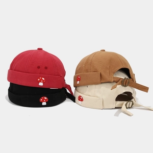 Fashionable brimless docker hats in four colors with cute mushroom patch and metal buckle