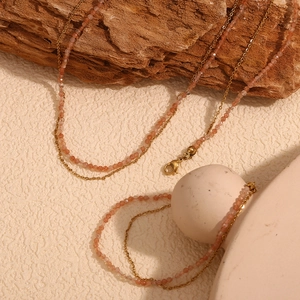 18K gold plated stainless steel sunstone beaded layered necklace on rustic wood background
