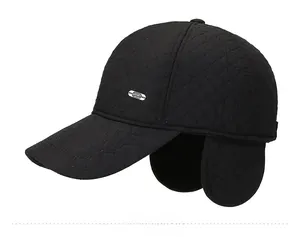 Detail of black quilted winter baseball cap featuring ear flaps and metal sport emblem