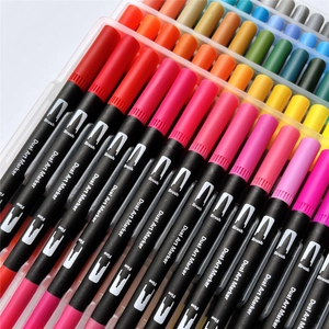 Close-up of vibrant dual-tip markers with brush and fine tips in a transparent case