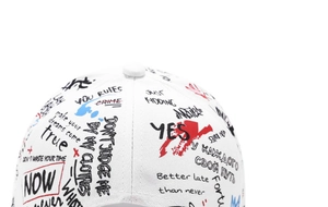 Close-up of white graffiti baseball cap featuring red and black street style prints