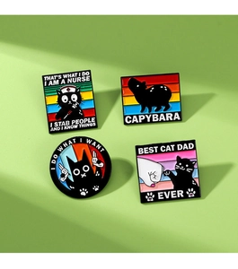 Detailed view of four cartoon enamel pins featuring nurse cat and capybara designs