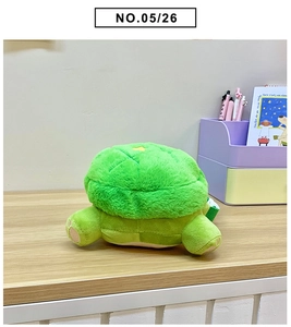 Close-up of green plush turtle bag with pineapple-patterned shell and yellow star detail