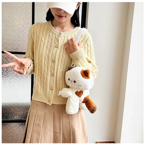 Detail of plush calico cat crossbody bag with brown heart embroidery and white strap