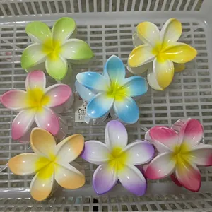 Colorful plumeria flower hair claws in a variety of vibrant gradient matte finishes