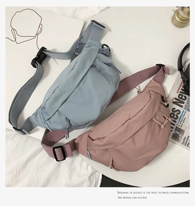 Detail view of nylon waist bags in light blue and grey pink with adjustable straps