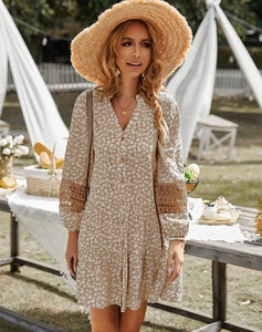 Close-up of brown floral mini dress with delicate lace patchwork and V-neck detail