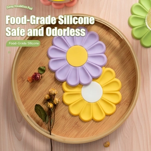 Daisy shaped heat resistant silicone placemats in yellow and purple on wooden tray