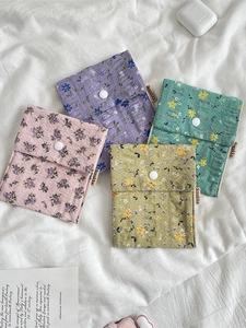 Quilted floral sanitary napkin storage bags in four pastel colors with snap buttons