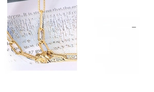 Detail of 18k gold plated safety pin chain with star pendant and secure lobster clasp