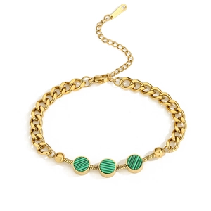 Detail of gold titanium steel bracelet featuring green shell inlays and mixed chain links