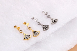Detailed view of gold and silver fan-shaped rhinestone earrings with Forever Love engraving