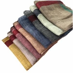 Stack of thin solid wool scarves in Morandi colors with tassels and vintage dyed edges