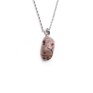 Irregular natural pink stone pendant necklace with silver twisted rope chain on white background