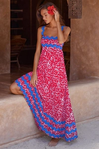 Detail of red and white abstract print maxi dress with blue scalloped ric rac trim borders