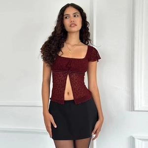 Detail of square neckline with bow and split hem on burgundy lace slim top