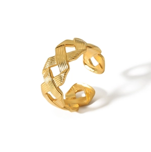 Macro shot of gold stainless steel braided ring showing detailed twisted texture on white background