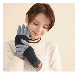 Detail of warm wool touchscreen gloves in blue and gray worn by a model in winter