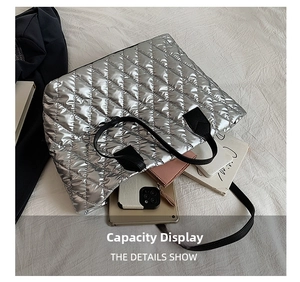 Detailed capacity display of silver quilted tote bag with tablet and daily essentials