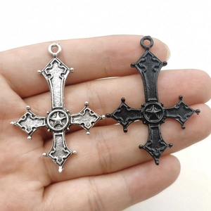 Detail of gothic inverted cross pendants in antique silver and black finish with star relief