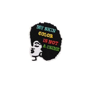 Embroidered black woman silhouette patch with My Skin Color Is Not A Crime slogan