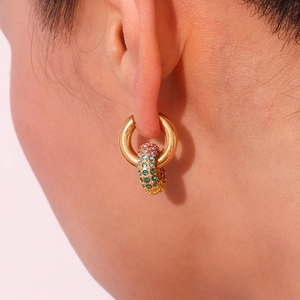 Close-up of gold stainless steel hoop earrings with colorful pavé cubic zirconia charms