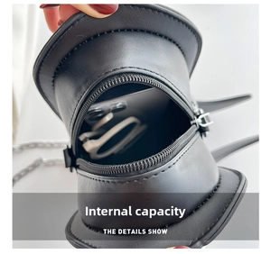 Internal view of the creative hat-shaped crossbody bag showing phone and sunglasses storage