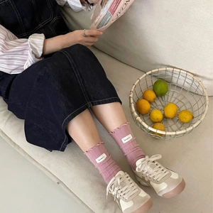 Pink ruffle trim crew socks in vintage rose cotton with ribbed texture and side label