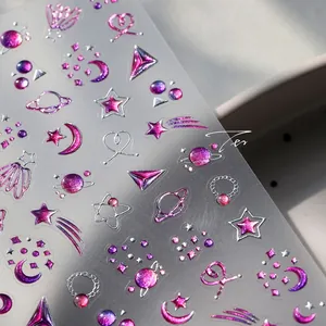 Macro detail of 3D embossed universe nail stickers with metallic moon and star patterns