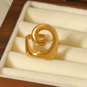 Macro view of 18K gold plated spiral hollow ring on a velvet jewelry box inner