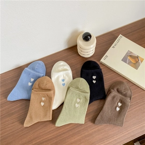 Detailed view of colorful cotton socks with heart embroidery in six vibrant colors