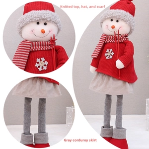 Detail of Christmas snowman plush featuring red knit textures and grey corduroy skirt fabric