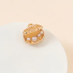 Detail of gold shell pendant with white pearls inside for DIY jewelry making