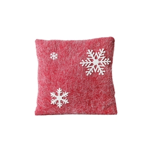 Red Christmas square felt pillow with white snowflake patterns on a white background