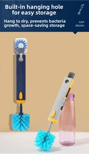 Detail of the multi-functional 4-in-1 bottle brush showing bristles and sunflower hook