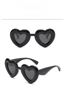 Detailed views of heart-shaped polarized sunglasses in glossy black acetate frame