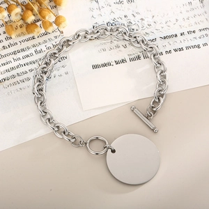 Detailed macro view of silver titanium steel O-chain with polished round tag and OT clasp
