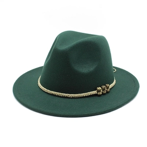 Detail of dark green wool fedora with woven beige band and vintage gold beads