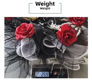 Halloween wreath weight measurement showing 259g with red roses and skeletal hands