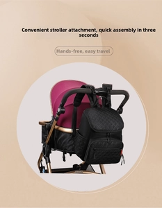 Close-up of black quilted diaper bag with stroller straps for easy hands-free travel