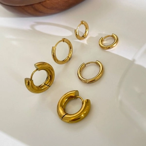 Three-piece set of polished golden titanium steel hoop earrings in various sizes for women