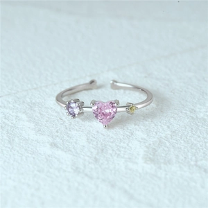 Macro view of S925 silver adjustable ring with pink heart-shaped stone and colorful gems